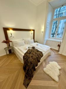 a large bed in a room with a large window at Maison Frank in Budapest