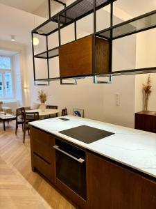 a kitchen with a counter top and a dining room at Maison Frank in Budapest