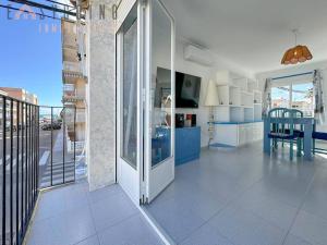 a living room with a sliding glass door and a table at ¡El Pescador - junto al mar! in Santa Pola