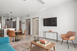 a living room with a couch and a table at Cozysuites PHX RORO Gym Pool Pets Parking #12 in Phoenix