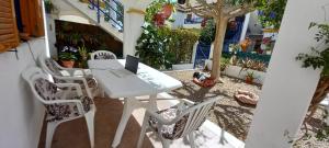 a white table and chairs with a laptop on it at Casa Chiki in Vera