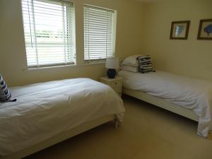 a bedroom with two beds and a window at The Lodge - Bidford Grange Golf Course in Bidford
