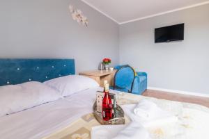 a room with a bed with a tray on it at ReveliQa2 in Pobierowo