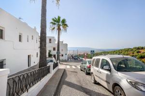 a group of cars parked on the side of a street at Casa El Muro in Vejer de la Frontera