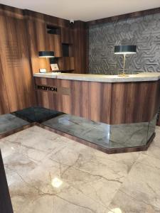 a lobby with a reception desk in a building at ROİ HOTEL İZMiR in İzmir