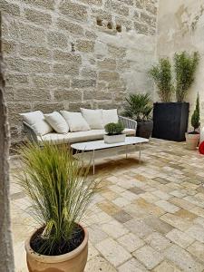 a living room with a couch and some plants at Appartement de charme avec cour in Avignon