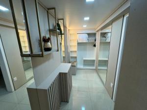 a hallway of a home with a walk in closet at Hotel Joaçaba in Joaçaba