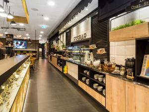 a store aisle with a counter and a restaurant at the niu Cobbles in Essen