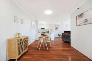 a living room with a table and a kitchen at Sky-view 2B2B1G in Hurstville -1 min to Westfield in Sydney