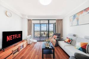 a living room with a couch and a tv at Sky-view 2B2B1G in Hurstville -1 min to Westfield in Sydney