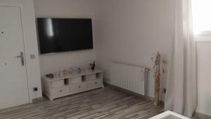 a white room with a television on a wall at Casa dess in Hospitalet de Llobregat