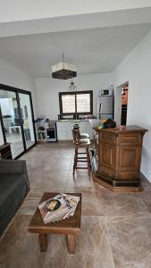 a living room with a couch and a table at Moller Masi - Ayllu Huasi in Purmamarca