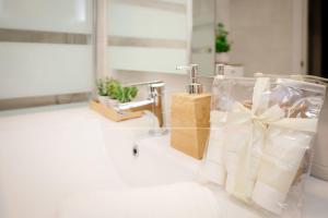 a bathroom sink with a towel dispenser and a faucet at BelMonStays Lubina del Sol, Riviera, Mijas Costa in Mijas Costa +8 photos
