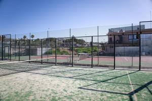 a tennis court with a net at BelMonStays Lubina del Sol, Riviera, Mijas Costa in Mijas Costa