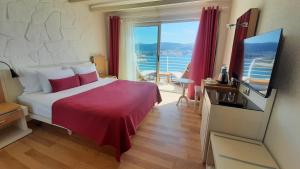 a hotel room with a bed and a large window at Prive Hotel Bodrum - Adult Only in Bodrum City