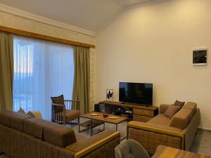 a living room with two couches and a television at Villa Ghizlane in Kas