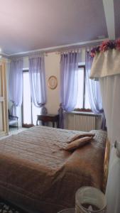 アルバにあるLA CASA DEI MASUE'のベッドルーム1室(青いカーテン付きの大型ベッド1台付)