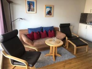 a living room with a couch and two chairs and a table at Yachthafenresidenz-Wohnung-9302-918 in Kühlungsborn