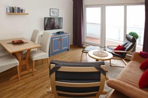 a living room with a couch and a table at Yachthafenresidenz-Wohnung-9302-918 in Kühlungsborn