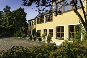 an exterior view of a house with a driveway at Landhotel Hallnberg in Walpertskirchen