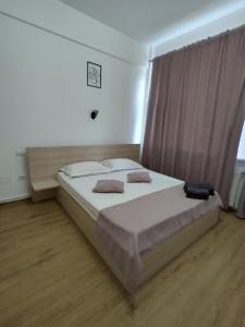 a large bed in a bedroom with a large window at Puzzle Magic in Piteşti