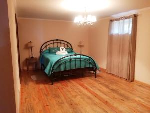 a bedroom with a bed with a stuffed animal on it at Apartamento Solar dos Castanheiros in Prainha de Baixo