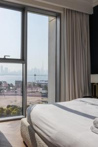 a bedroom with a bed and a large window at Burj Khalifa View & Creek lagoon in Dubai
