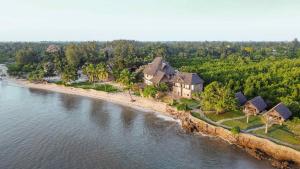 an aerial view of a house on a island in the water at Mwazaro Beach Lodge in Shimoni