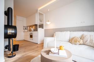 a living room with a white couch and a table at Quartier am Strand - App 05 in Neuhof