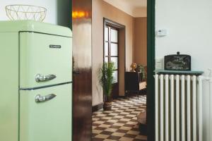 a room with an old refrigerator and a radiator at Le Bédier in Angers