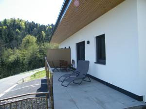 a balcony with a table and chairs on a house at Haus Schloßbergblick in Leutschach