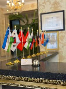 a table with many different flags on it at Orient Inn in Tashkent