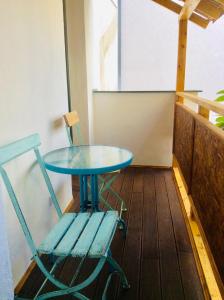 a blue table and a chair on a balcony at Apartment Sirius A in center of CB. in České Budějovice +11 photos