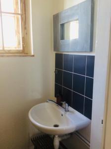 a bathroom with a sink and a mirror at Apartment Sirius A in center of CB. in České Budějovice
