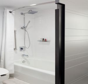 a white bathroom with a shower and a toilet at Orlando World Center Marriott in Orlando