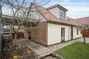 a brick house with a red roof at Come Stay - Stilfuld Elegance for 4 med pejs in Aarhus