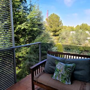 una panchina su un balcone con vista sugli alberi di Entre el mar y PortAventura 2 a Salou