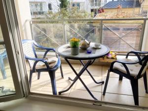 a table and two chairs on a balcony at Ferienwohnung 1 1 10 Inselstrand in Ahlbeck