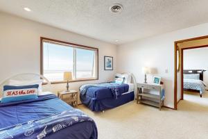 a bedroom with two beds and a large window at 2 Bed 2 Bath Vacation home in Waldport in Waldport