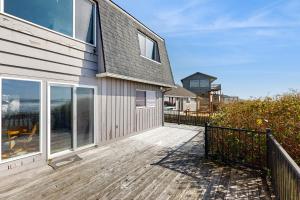 a house with a wooden deck next to a building at 2 Bed 2 Bath Vacation home in Waldport in Waldport