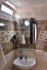 a bathroom with a sink and a mirror at MELLES OTEL in Antalya