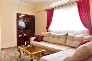 a living room with a couch and a table at MELLES OTEL in Antalya
