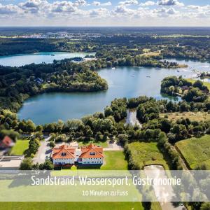 an aerial view of a house on a lake at Villa Moorstern in Aurich
