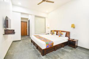 a bedroom with a bed and a television in it at FabHotel Prime Kantara in Lonavala