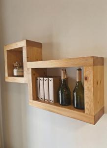 una estantería de madera con botellas de vino en la pared en Apartmán Sirius B en České Budějovice