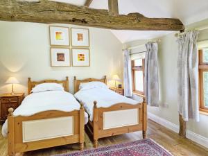 two twin beds in a room with two windows at Walnut Cottage - Horsham in Horsham