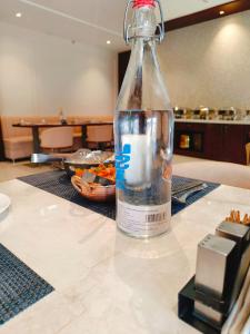 a bottle of water sitting on top of a table at Hotel Akosha 