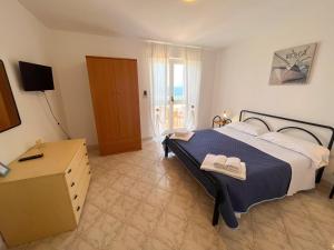 A bed or beds in a room at NaturAmare Apartments Palinuro