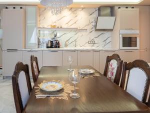 a wooden table with wine glasses on it in a kitchen at Paradise Center Premium Suite 1 in Sofia