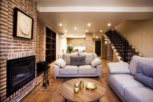 a living room with two couches and a fireplace at El Rincon De Jara in Caudiel